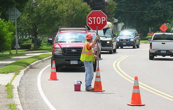 Worker directing traffic in a work zone