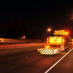 safety attenuator truck on highway road project at night