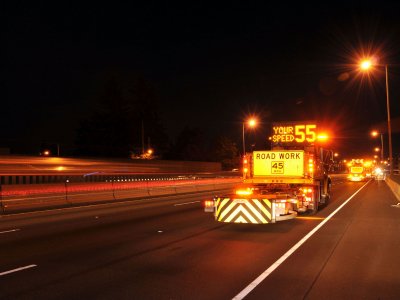 safety attenuator truck on highway road project at night