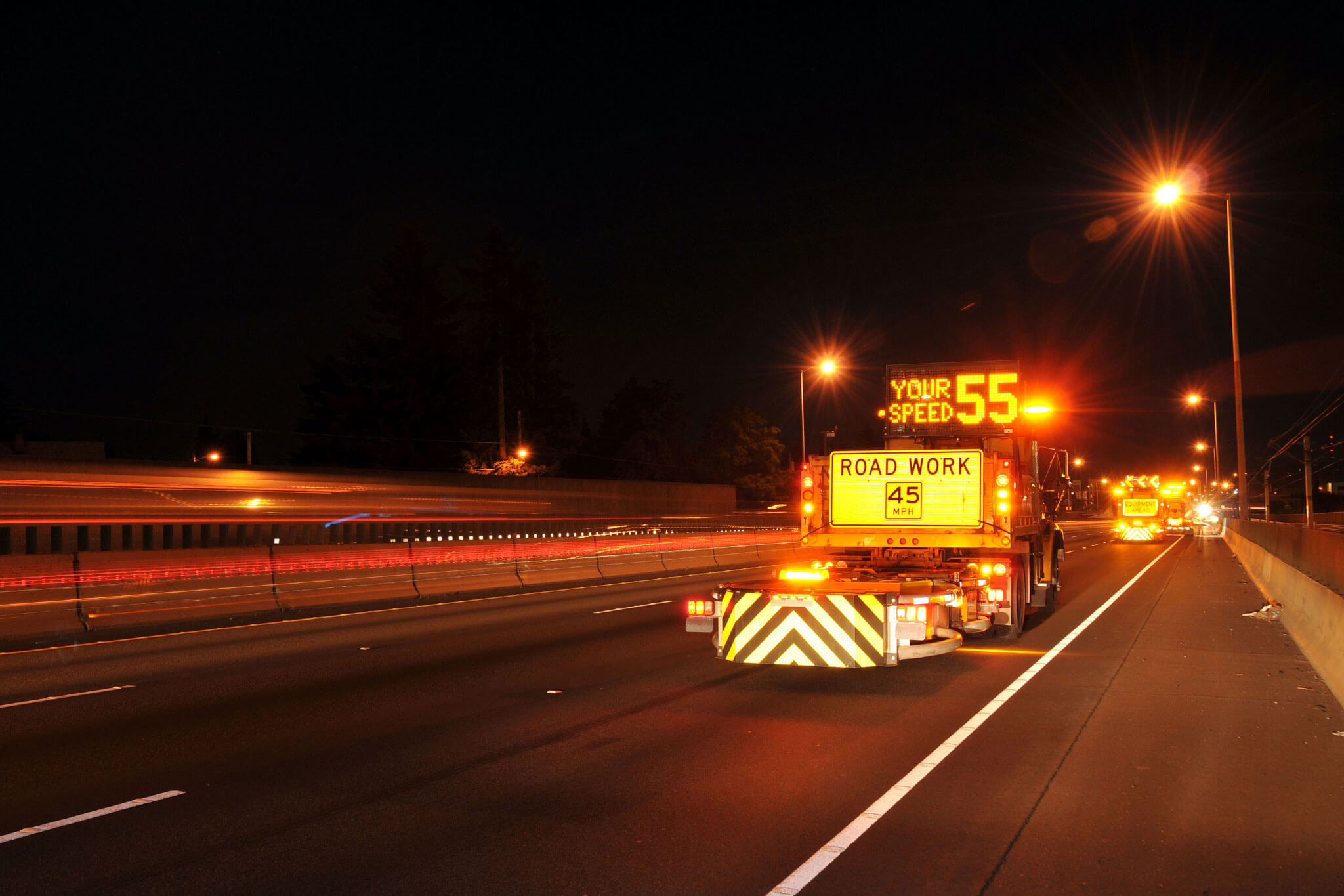 safety attenuator truck on highway road project at night