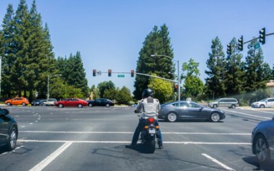 : motorcycle and traffic at a busy intersection