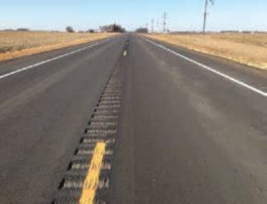 country road with milled rumble strips along the center line of the roadway