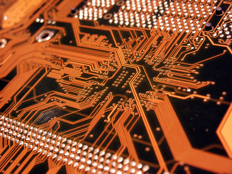 computer_circuitboard_orange_iS71322.jpg alt="computer circuit board