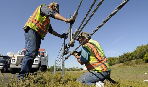 Minnesota DOT workers installing cable barrier