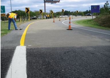 Roadway being paved with High Friction Surface Treatment