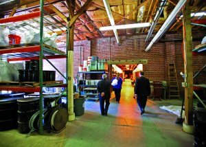 people walking through the materials-storage area of the asphalt lab