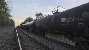 long freight train made up of tanker cars stretches to the horizon